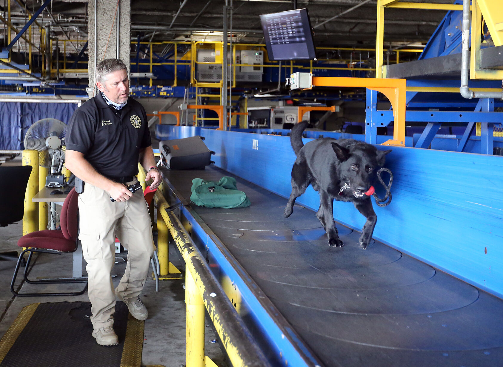 Lt. Jay Christmas with drug-sniffing dog Hector at Charleston airport